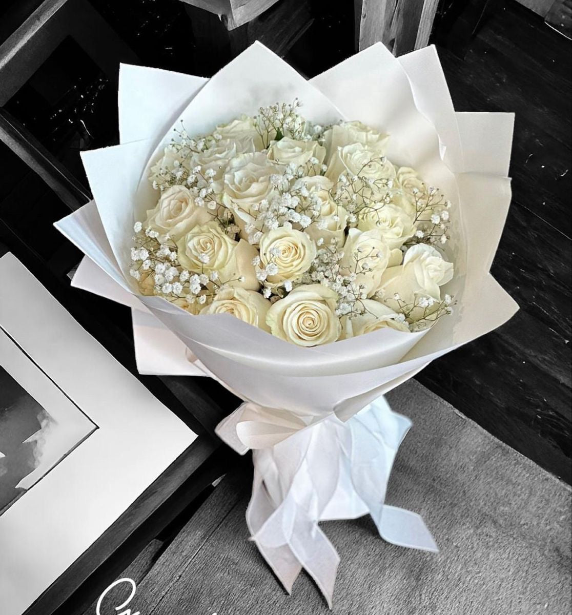 24 white roses with clear wrapping